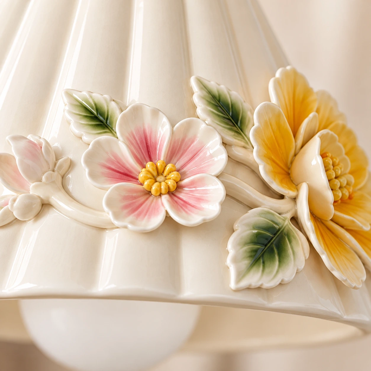 Raised ceramic floral relief on the shade