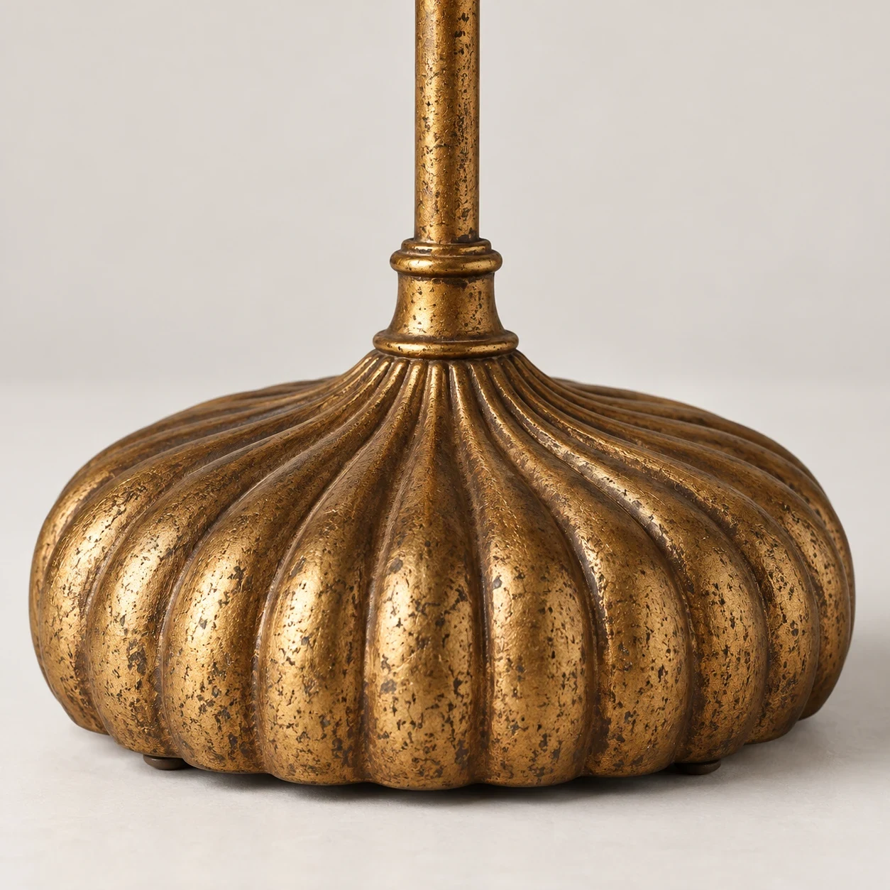 Close-up of distressed gold fluted iron base