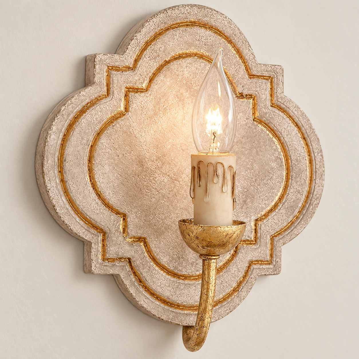 Close detail of the gold candle arm and wax-drip sleeve