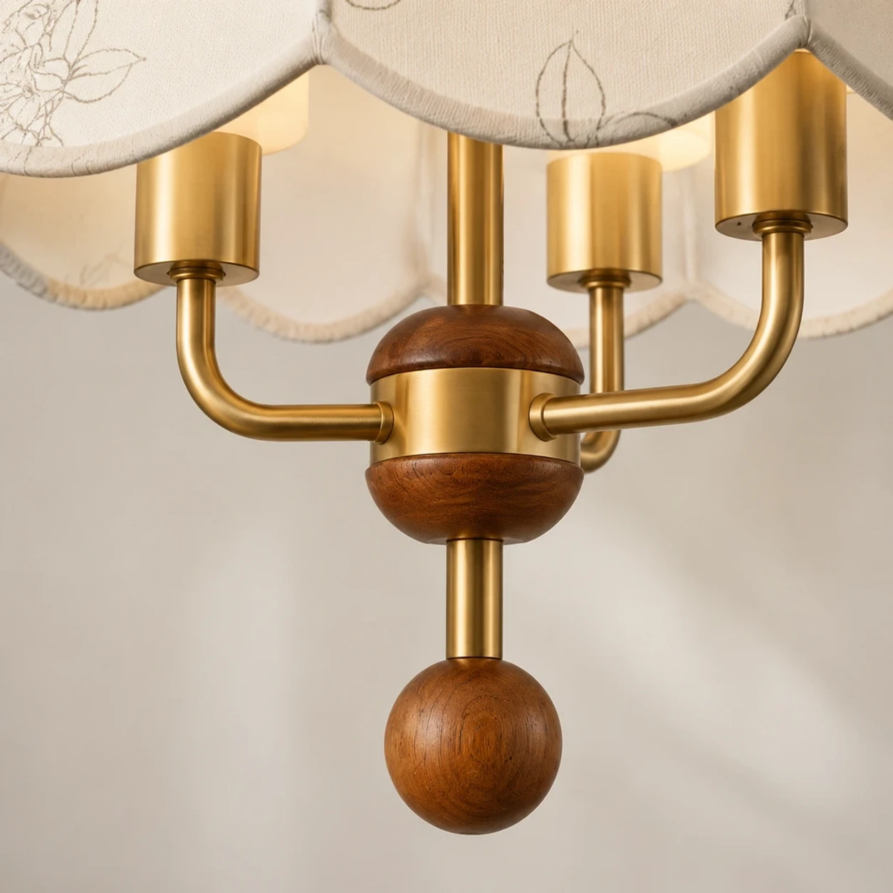 Close view of brass candle arms and wood finial