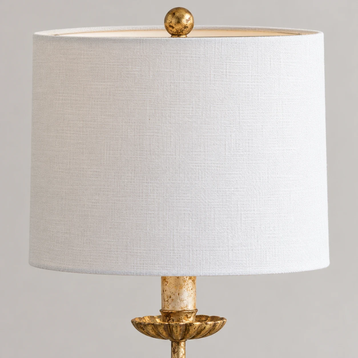 Close-up of fabric shade texture and gold ball finial